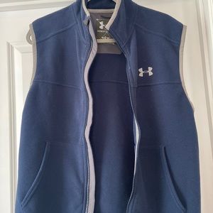 Under A.  fleece vest
